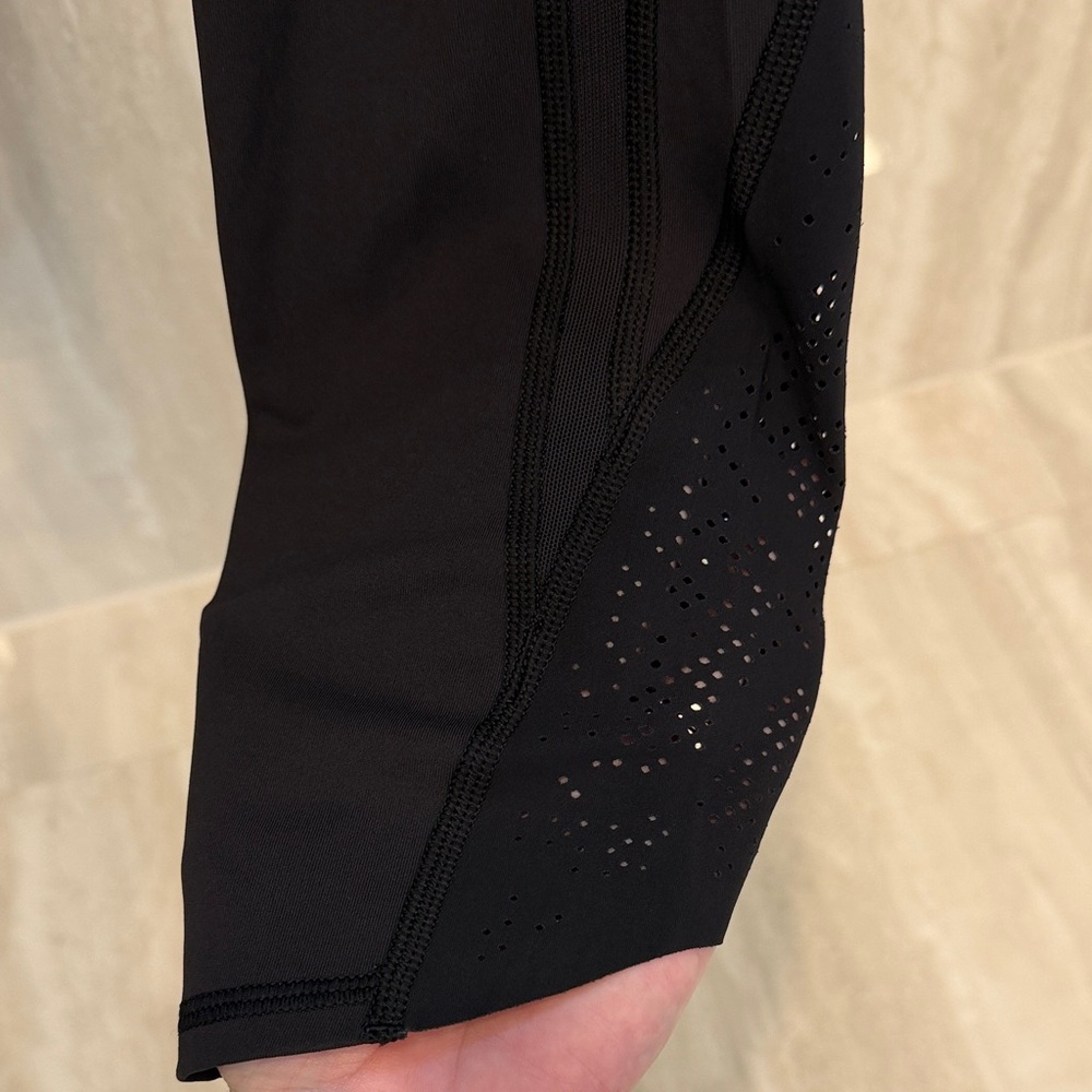 black crop lululemon tight with perforation detail